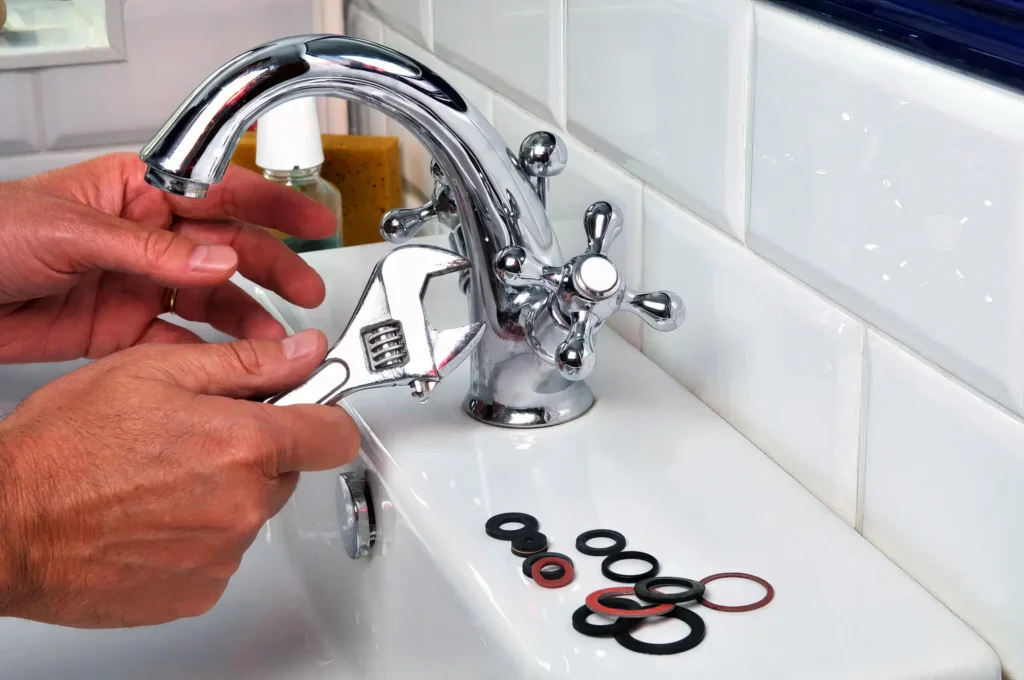 Plumber performing maintenance on a bathroom faucet in North Fort Myers