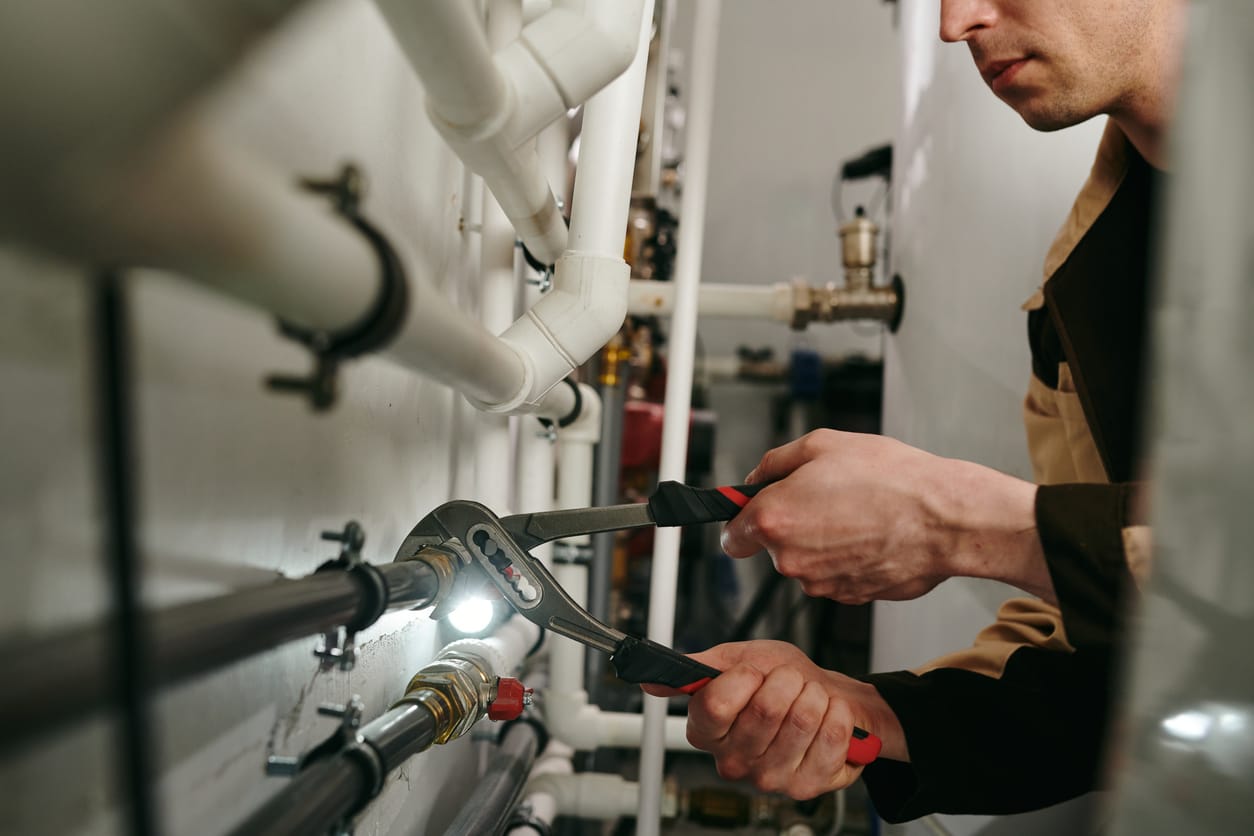 Plumbers maintaining commercial plumbing pipes in North Fort Myers