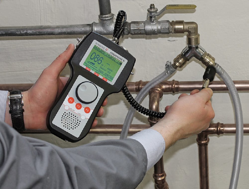 Plumber testing pipes with electronic leak detection equipment in North Fort Myers