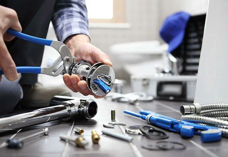 Technician repairing a plumbing fixture with professional tools in North Fort Myers