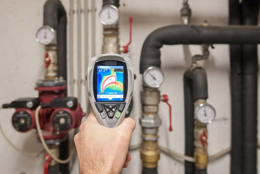 Plumber using a thermal imaging camera to inspect pipes in North Fort Myers