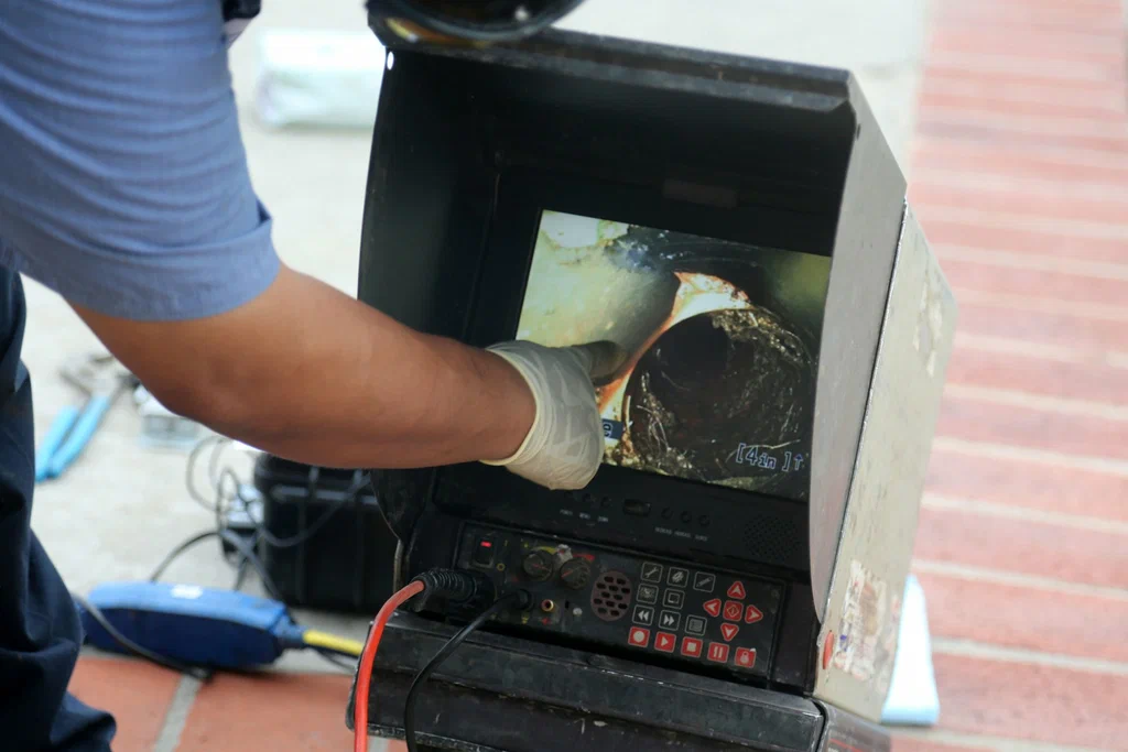 Technician viewing a drain inspection camera in North Fort Myers