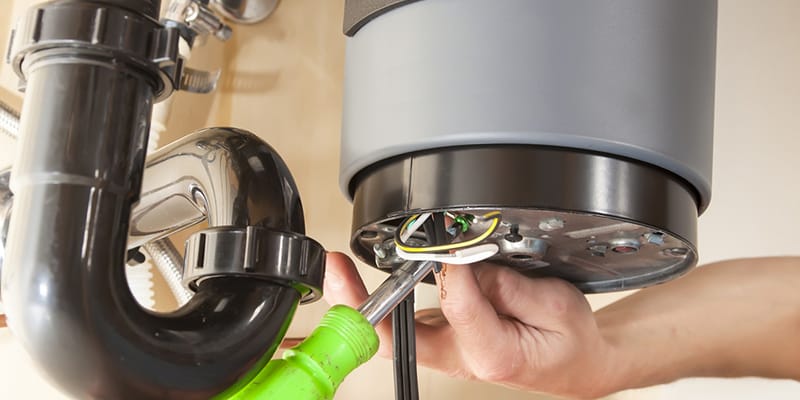 Technician repairing the heating element of a water heater in North Fort Myers