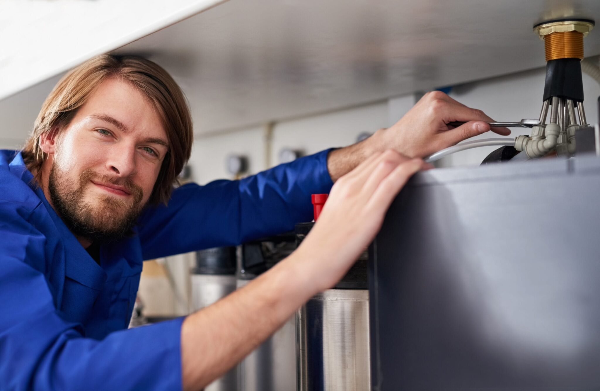 Technician servicing a residential water heater tank in North Fort Myers