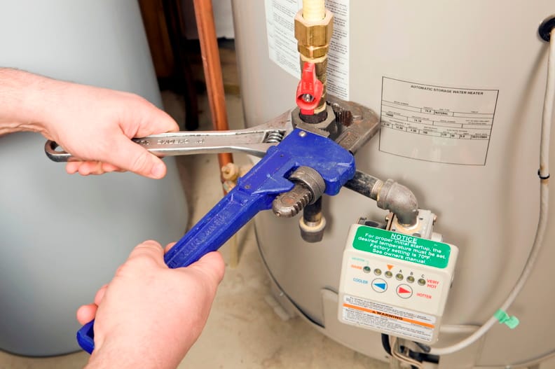 Plumber repairing a water heater valve in North Fort Myers